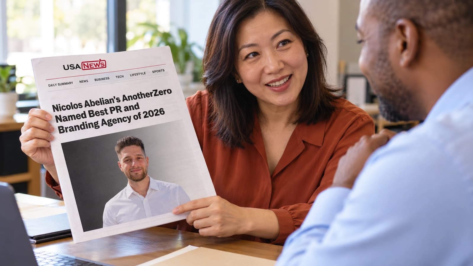 A prospect holds a printed USA News feature across the desk at a client meeting.